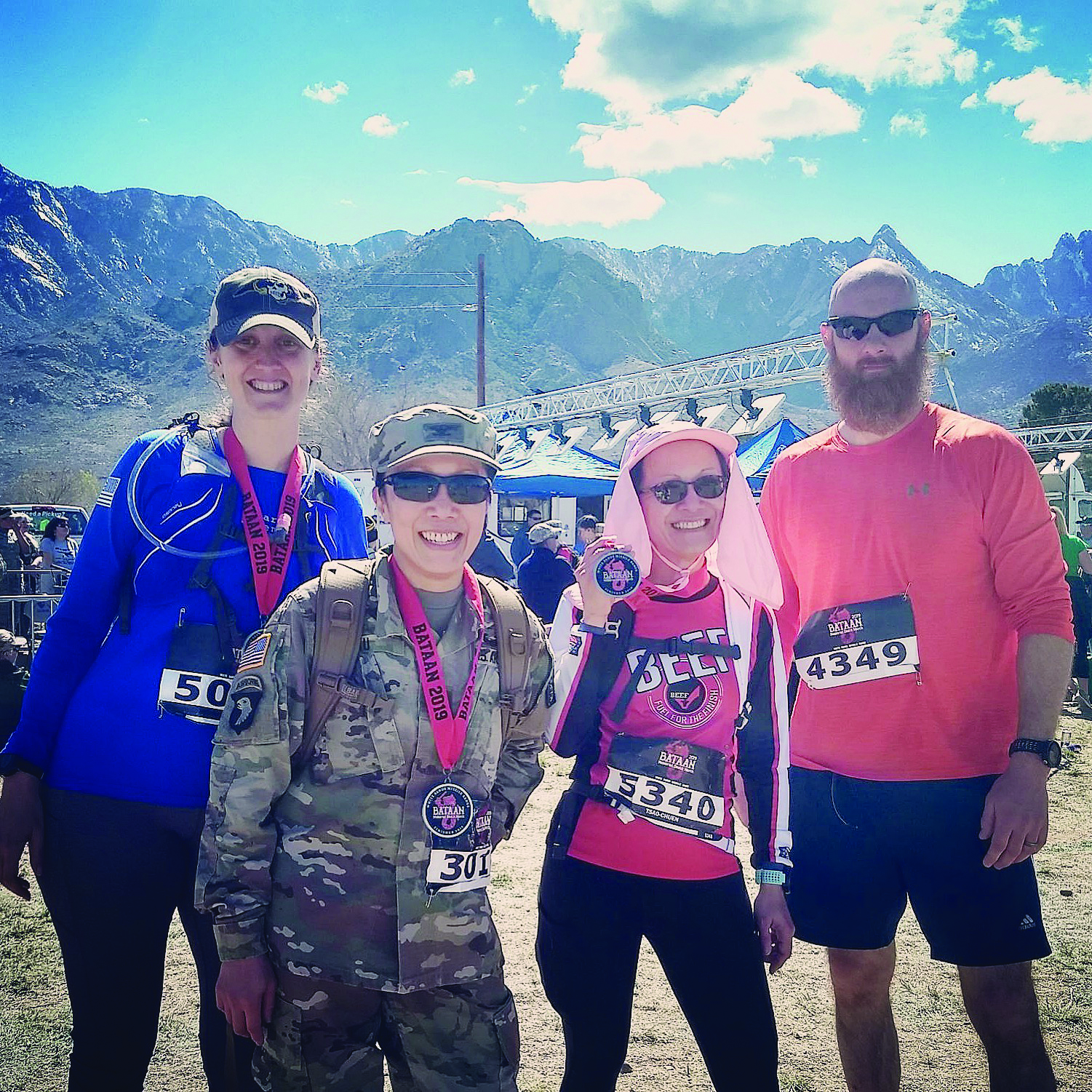At the finish line with their finishers’ medals. Left
        to right: Stacy Craver, COL Ku, COL Ku’s sister, and
        Ms. Craver’s husband. (Photo courtesy of COL Ku)